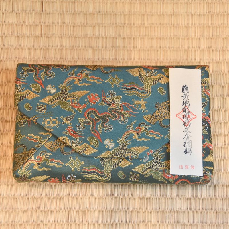Japanese Traditional patterned pouch with dragons on a textured surface