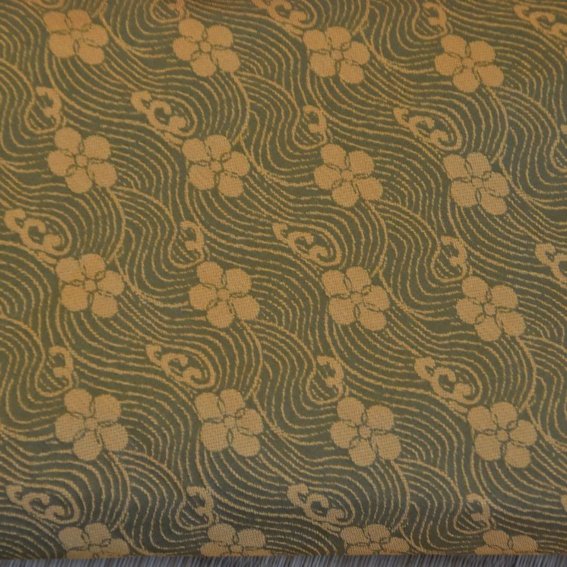 Textile with floral pattern on a green background