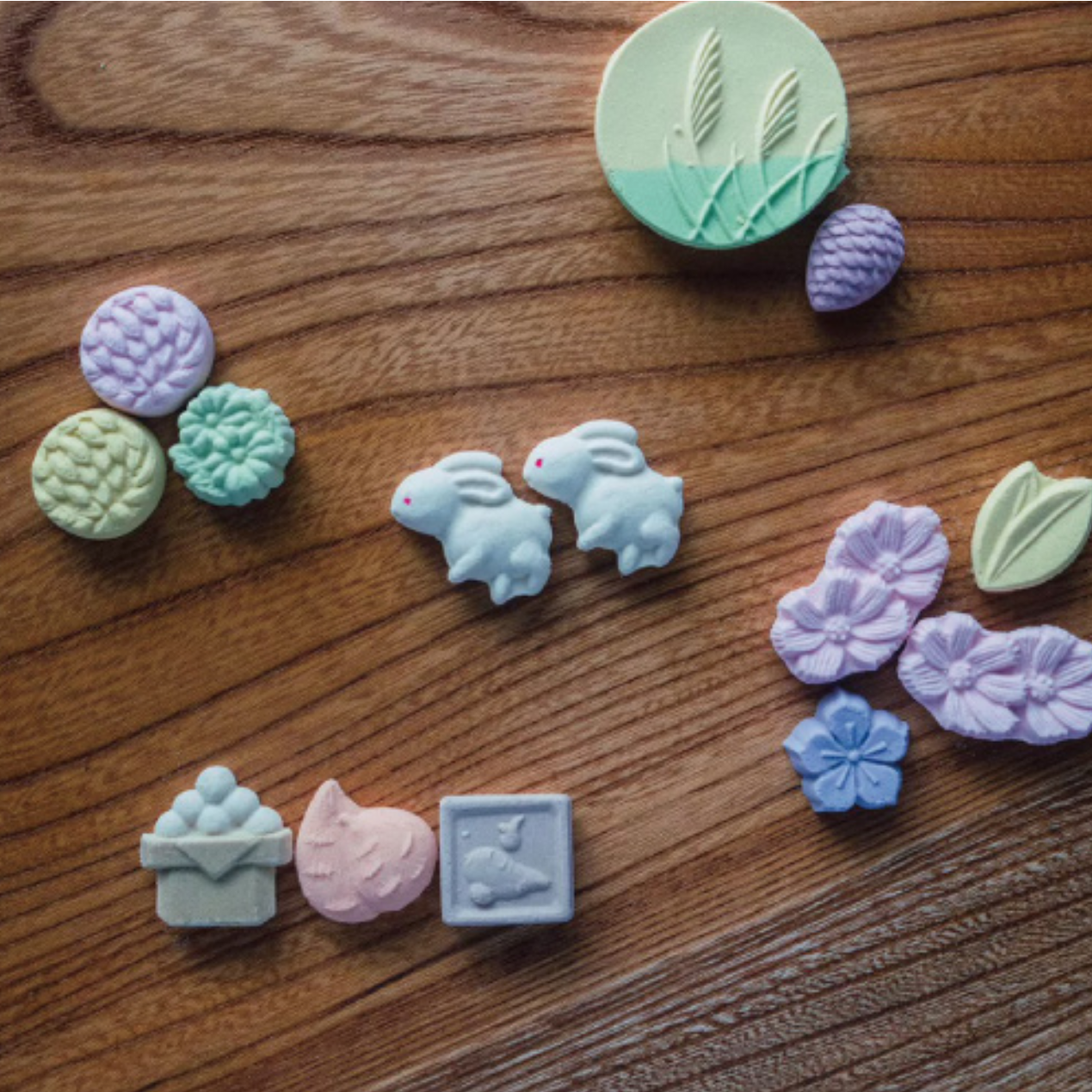 Pastel-colored clay stamps on a wooden surface