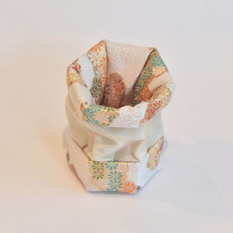 Hexagonal fabric pouch with floral pattern on a light background