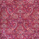 Close-up of a red patterned fabric with intricate designs
