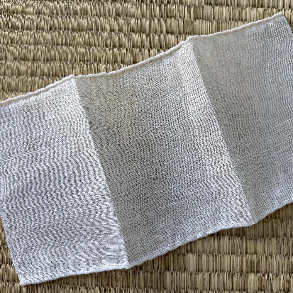 Gray fabric folded on a textured brown surface