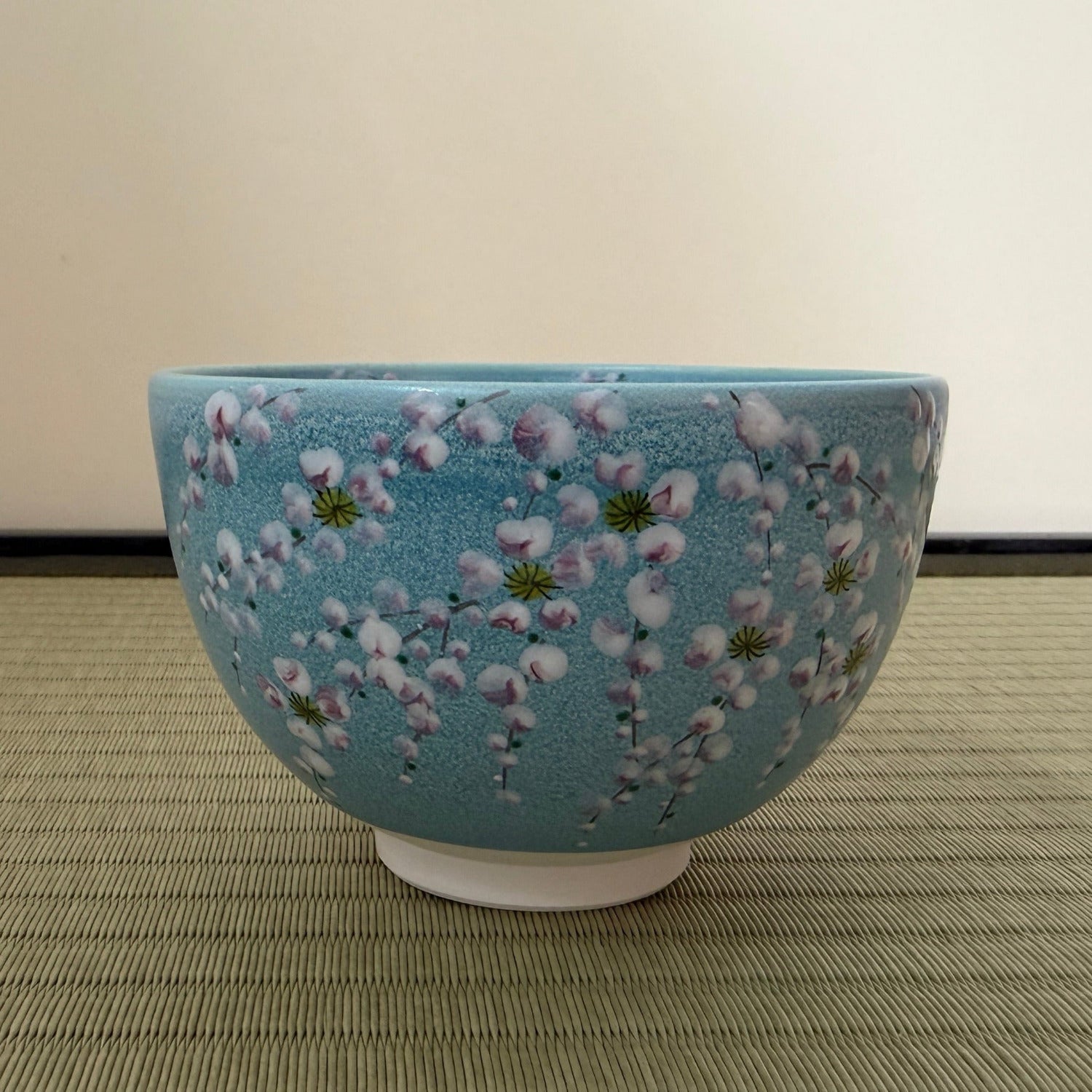 Ceramic bowl with floral design on a textured surface