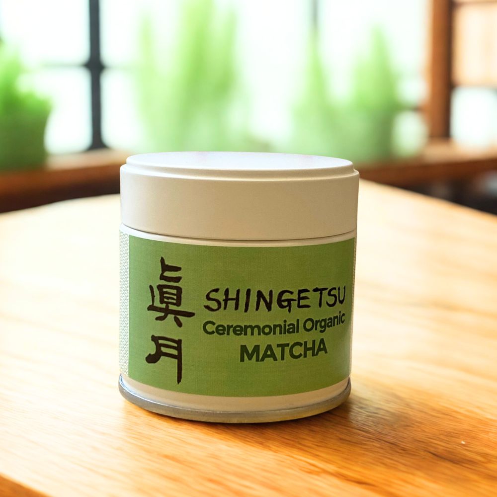 Ceremonial organic matcha container with green label on a wooden table