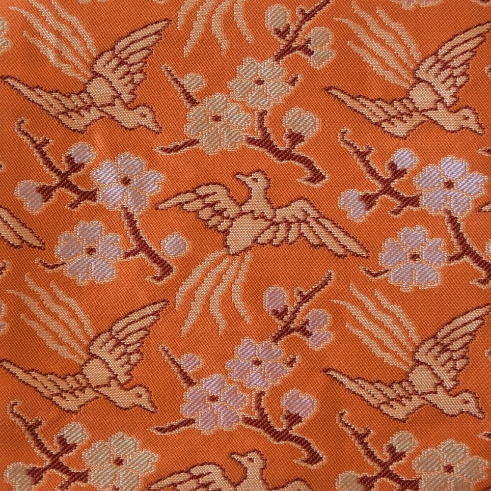Pattern of birds and flowers on an orange background