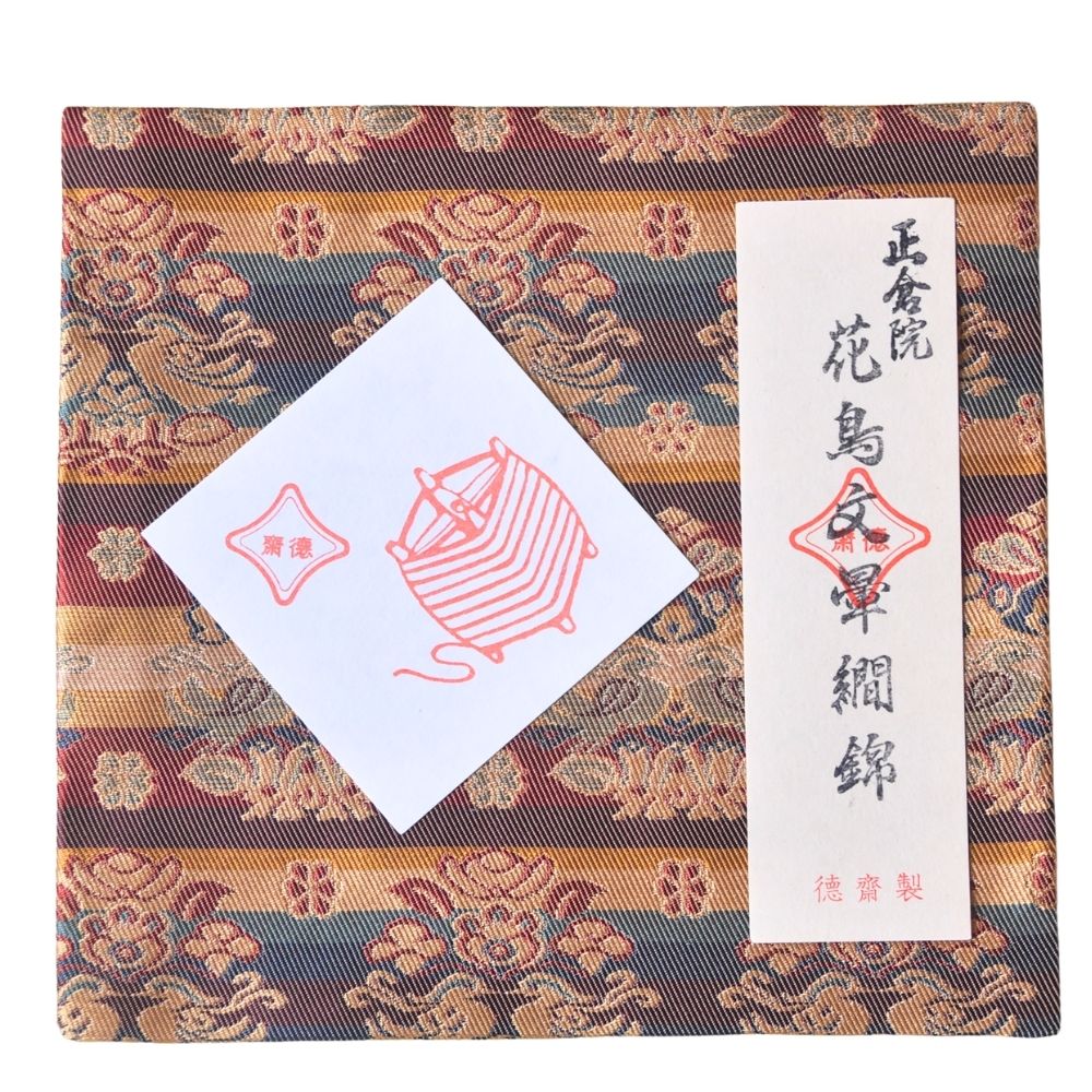 Decorative fabric with a traditional pattern and two cards on top