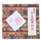 Decorative fabric with a traditional pattern and two cards on top