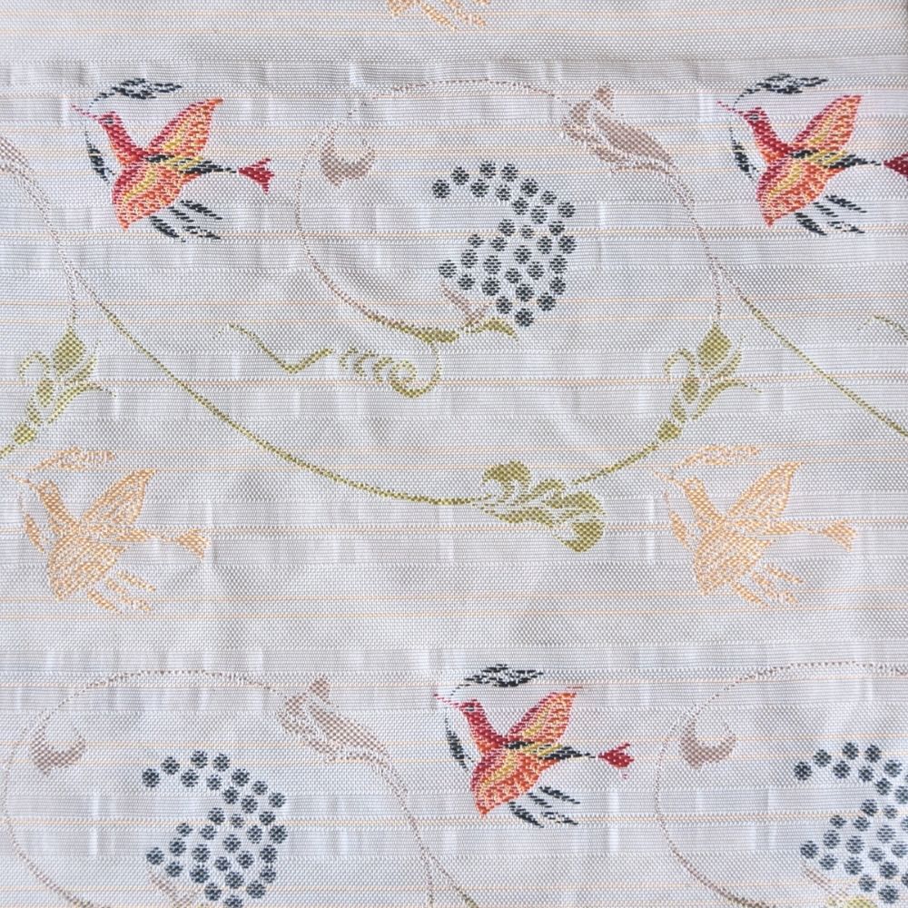 Kobukusa tea cloth used in Japanese tea ceromony. Close-up of cross-stitched fabric with birds and floral patterns