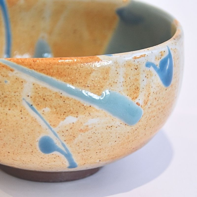 Ceramic bowl with blue decorative elements on a white background