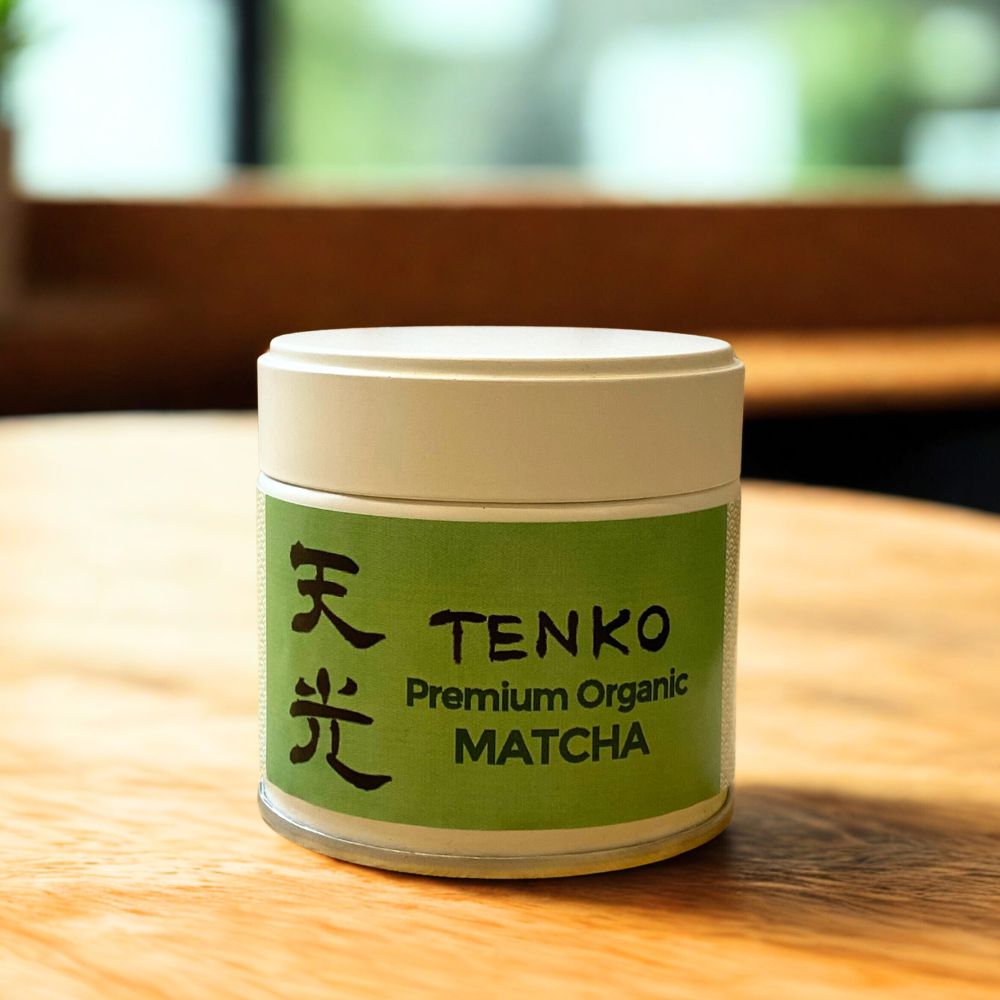 Tenko Premium Organic Matcha container on a wooden surface with a blurred background