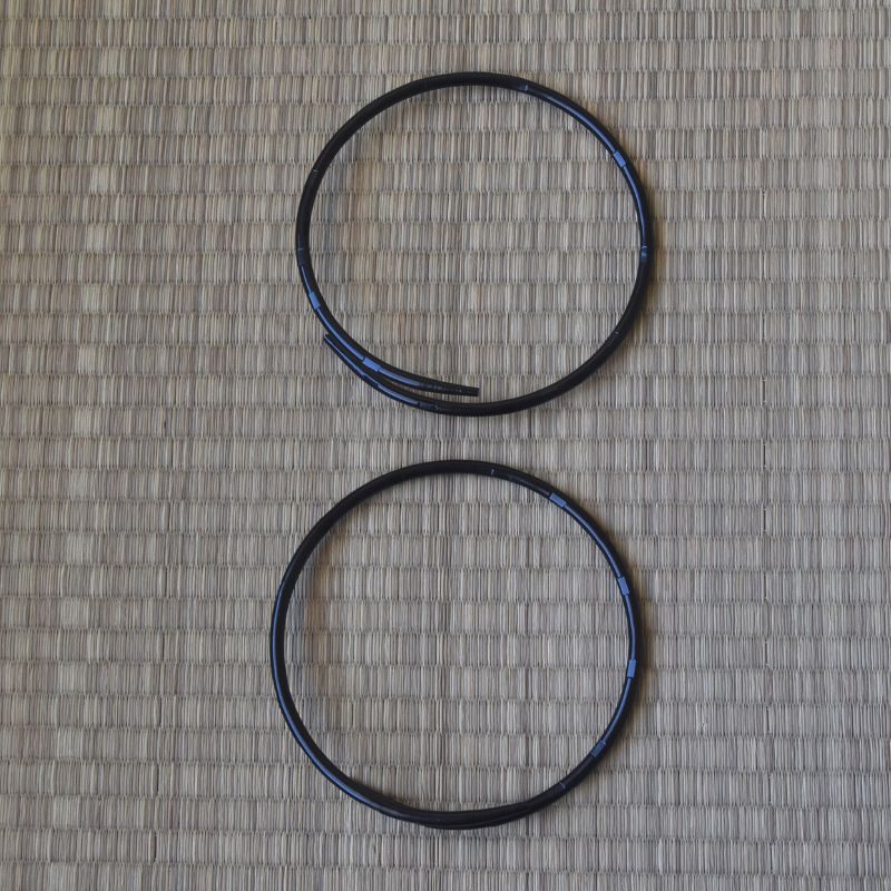 Two black circular objects on a textured gray surface