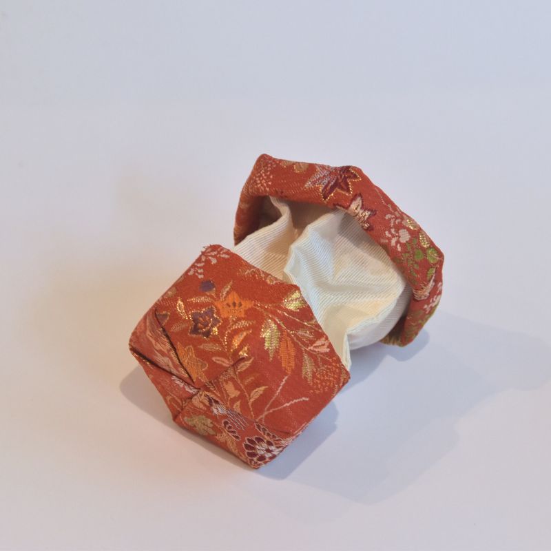 Hexagonal fabric container with floral pattern on a white background