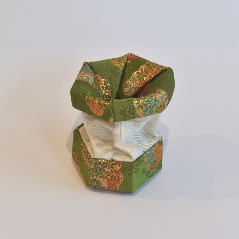 Hexagonal fabric box with floral patterns on a white background