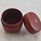 Wooden container with lid on a textured surface