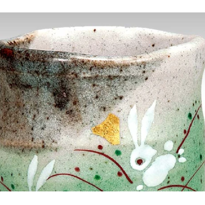 Ceramic container with rabbit design on a speckled background