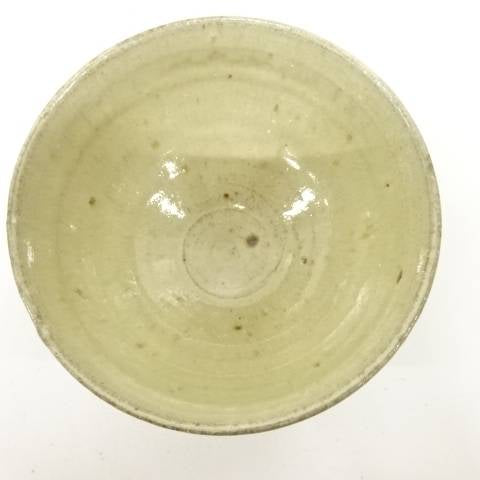 Top view of the Koijitsu matcha bowl showing its softly glazed interior, visible throwing rings, pale speckling, and natural firing variation.