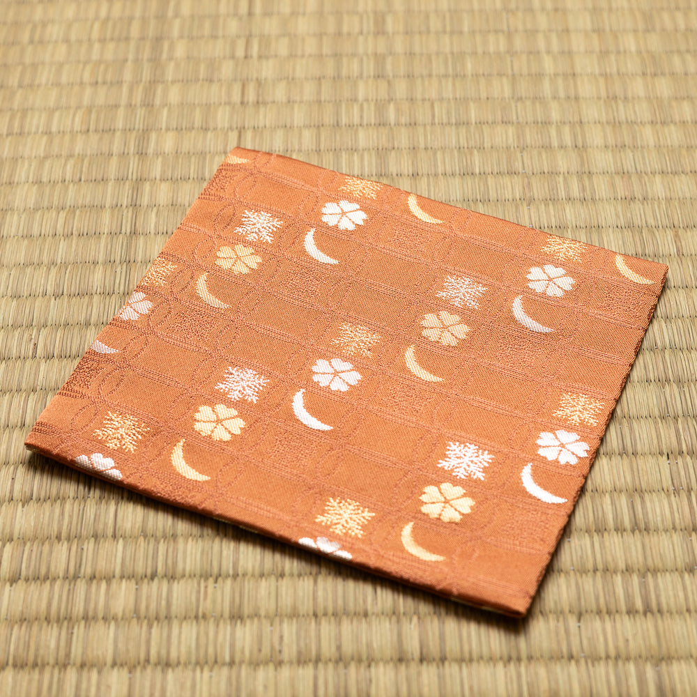 Angled view of the hand-sewn rose Chitose-bon kobukusa resting on a tatami surface.