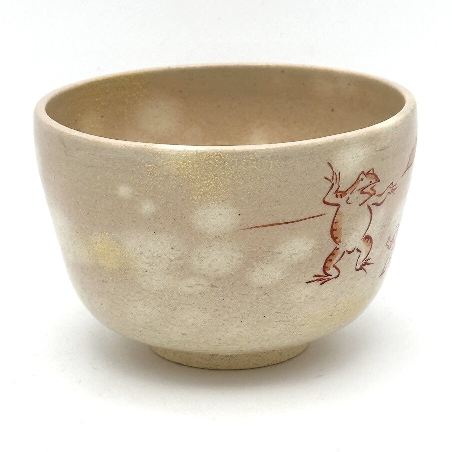 Side view of the Choju-Giga matcha bowl highlighting playful hand-painted animal figures on the warm beige glaze
