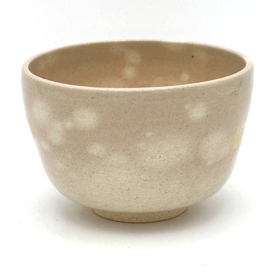 Reverse view of the Choju-Giga Kyo Ware chawan showing its softly speckled beige glaze and subtle hand-painted detail