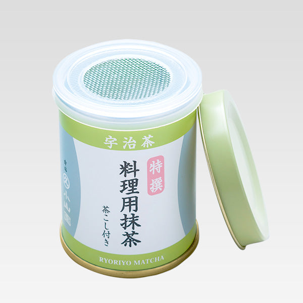 Green tea canister with Japanese text on a light gray background