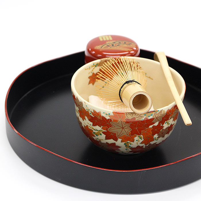 Autumn maple leaves matcha bowl by Eika Miyaji displayed with Japanese tea ceremony utensils