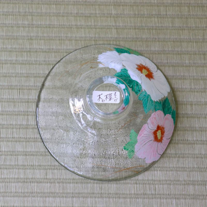 Bottom view of handcrafted glass matcha bowl showing the colorful Rose of Sharon floral design