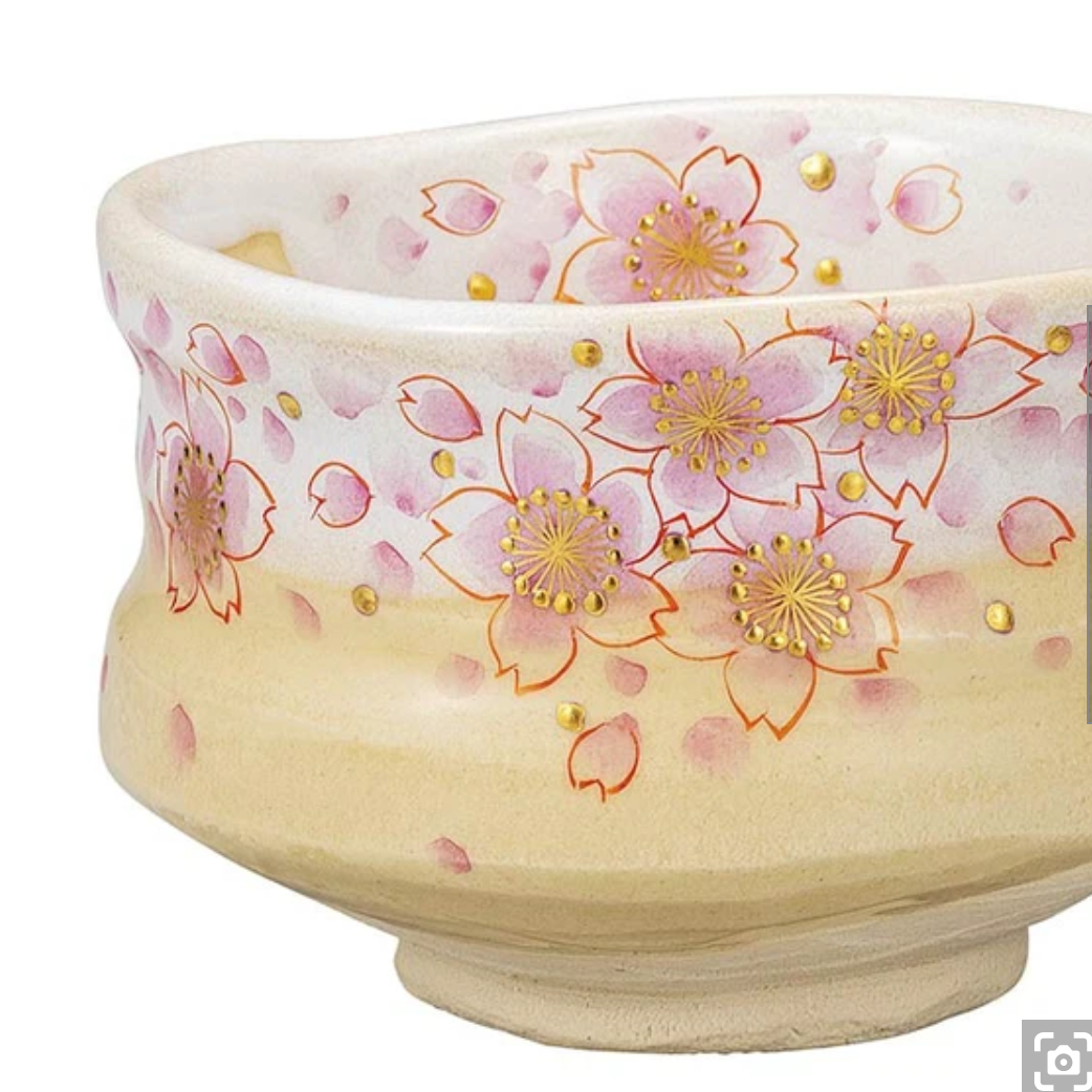 Right angled view of the hand-painted sakura matcha bowl showing its rounded chawan form, raised foot, and luminous gold-accented blossoms.