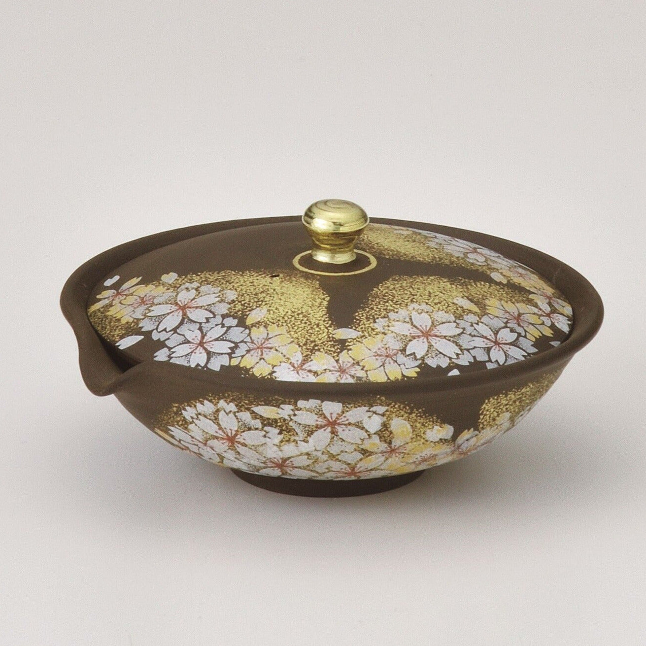 Decorative ceramic pot with floral design and gold accents on a white background