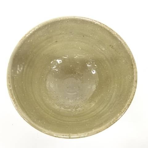 Top view of the Izumino Ware matcha bowl showing its softly glazed olive-beige interior with natural speckling and firing variation.