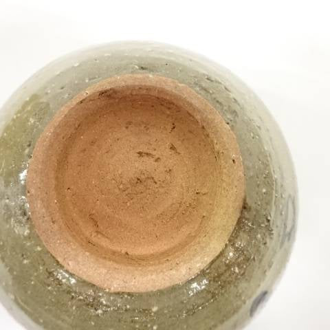 Underside view of the pre-owned matcha bowl showing the circular foot ring, exposed warm clay, and glaze surrounding the base.