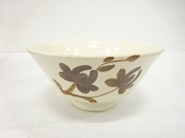 Front view of the Yukiwasou Buncheong chawan showing dark brown iron-painted flowers and leafy stems across a pale ivory surface.