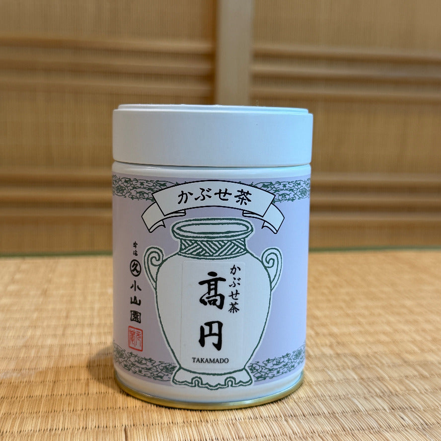 Tea canister with Japanese text and design on a wooden surface