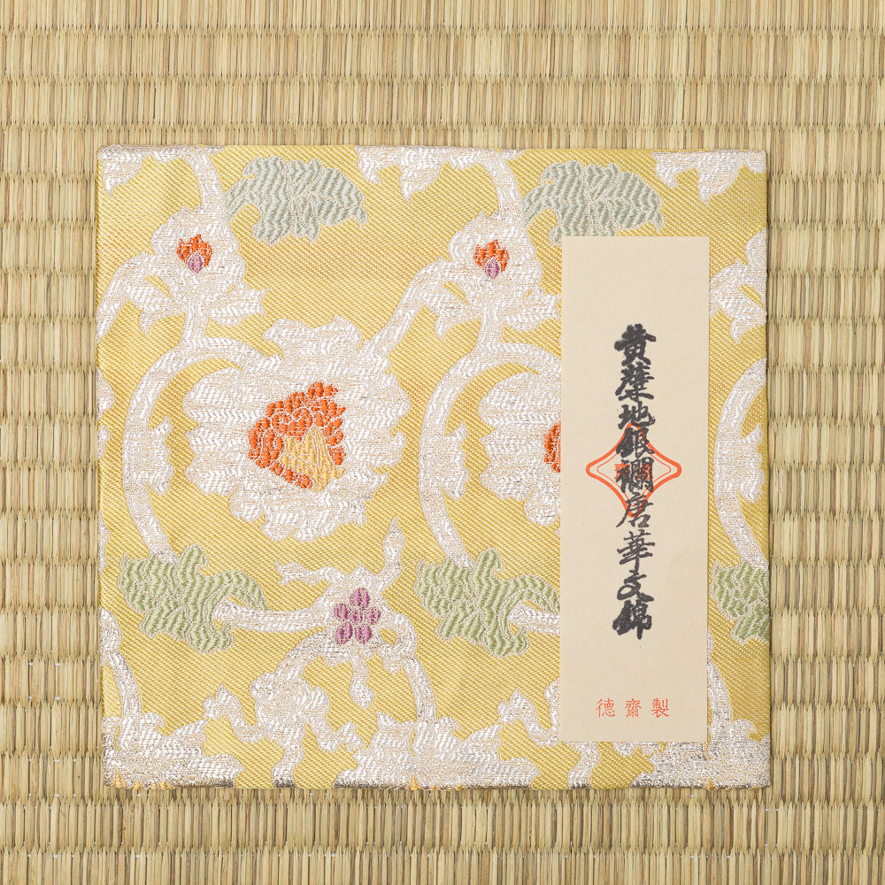 Japanese Nishijin silk kobukusa featuring silver brocade peony and arabesque motifs on a soft yellow background
