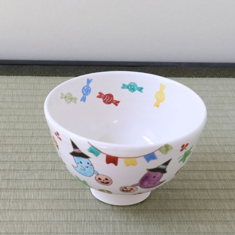 Top angled view of the Kyo Ware Halloween matcha bowl showing the white interior and colorful hand-painted ghost, pumpkin, and seasonal motifs around the bowl