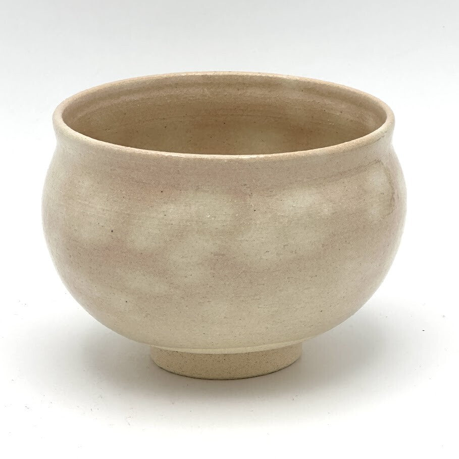 Reverse view of the Kyo-yaki Eda ni Suzume matcha bowl highlighting its rounded form and softly mottled warm beige glazed surface