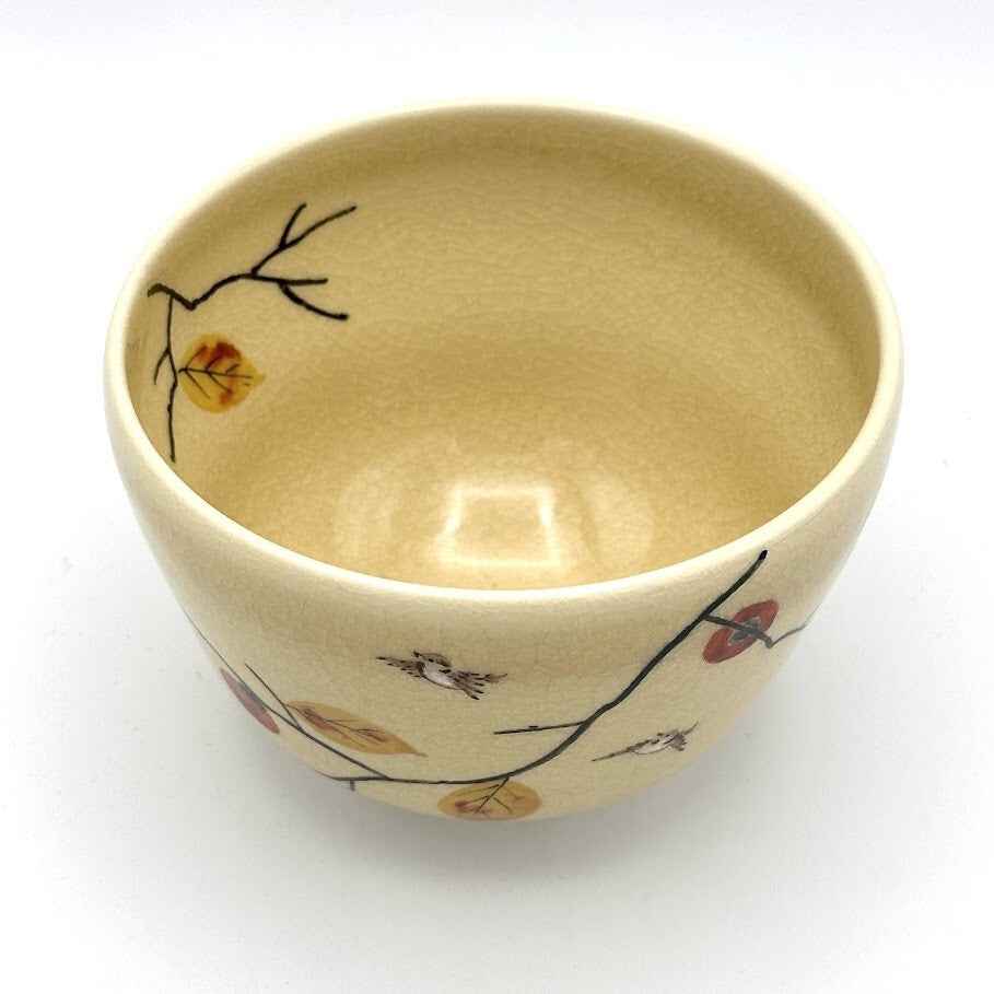 Top interior view of the Kyo-yaki Kaki ni Suzume chawan showing its warm beige glaze and hand-painted persimmon branch decoration around the rim