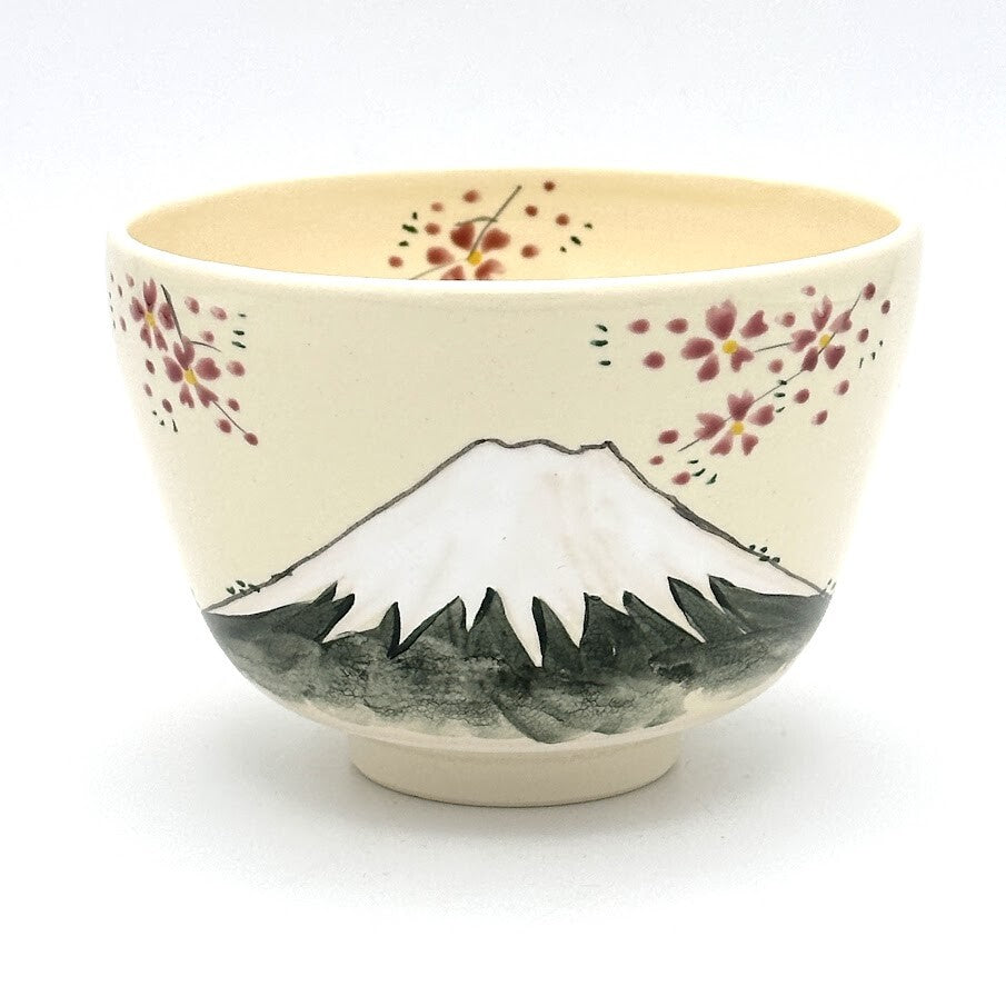 Hand-painted Kyo-yaki matcha bowl featuring Mt. Fuji with a snow-covered peak, dark green landscape, and delicate pink blossoms
