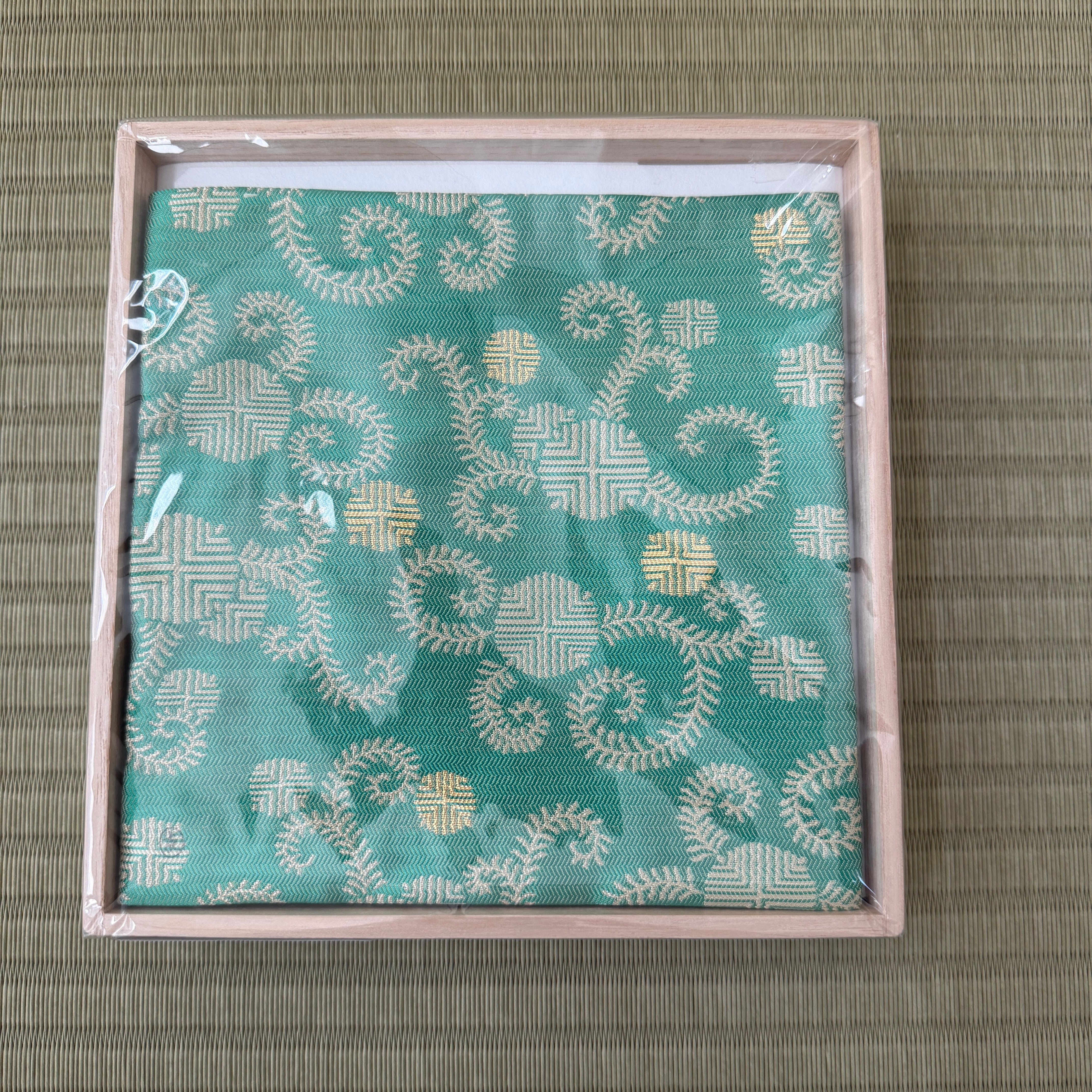 Turquoise Matsuman Shoha Zabosai Konomi silk kobukusa by Yuko Tsuchida displayed in its presentation box on tatami.