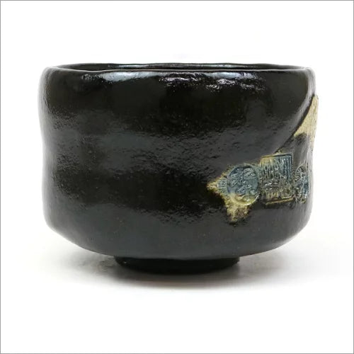Opposite side of the Black Raku matcha bowl showing blue-green numeral marks and small gold-toned accents on the glossy surface.