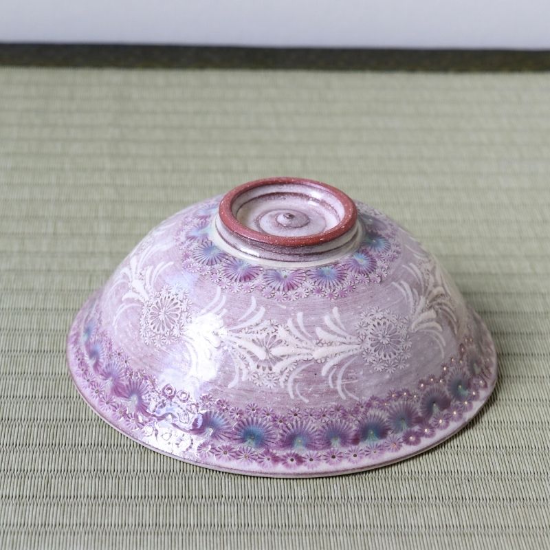 Bottom view of the Morisato Touraku Hira Chawan showing deep purple glaze, white floral decoration, and raised foot