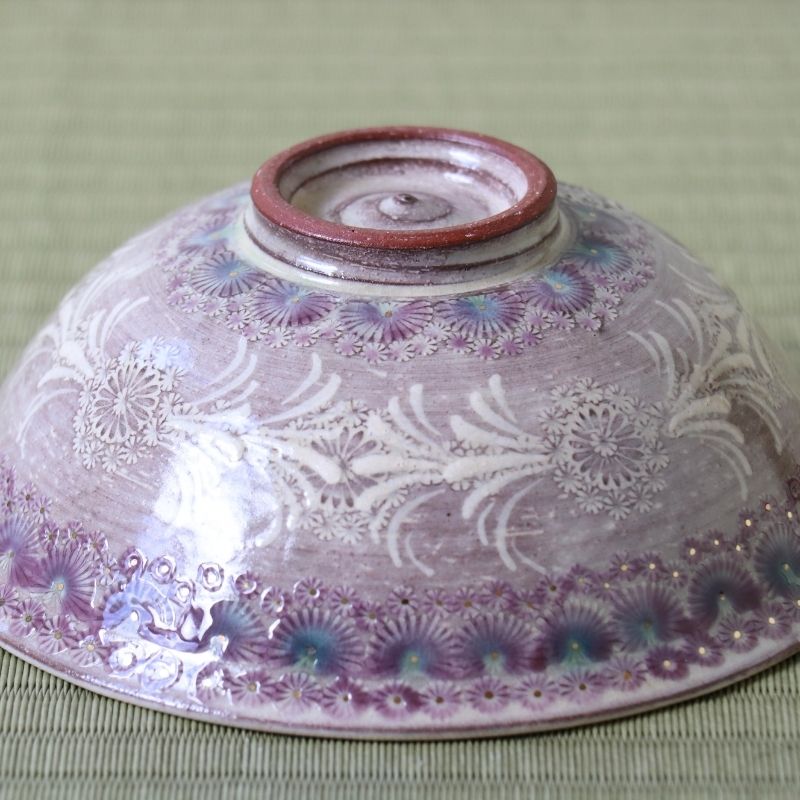 Underside view of the Morisato Touraku Hira Chawan with purple floral bands and detailed white botanical patterns