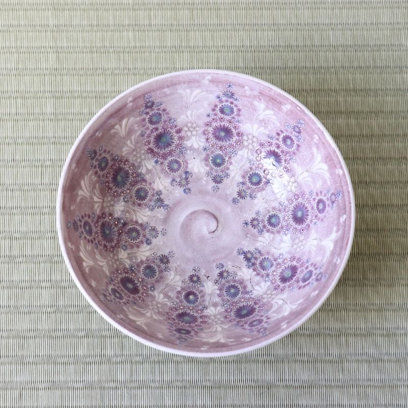 Top view of Morisato Touraku Hira Chawan showing radiating purple and turquoise floral patterns inside