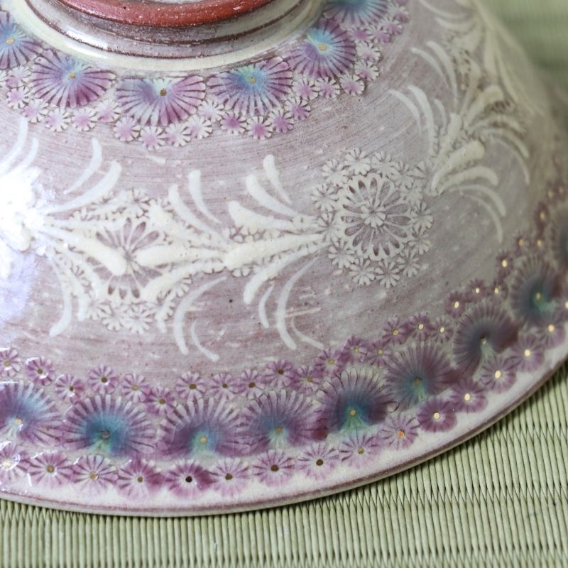 Close-up of the intricate white vine and floral Kyo-Mishima decoration on the deep purple Hira Chawan