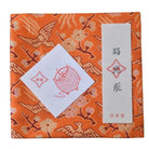 Decorative box with orange and gold pattern, featuring a white label and red design.