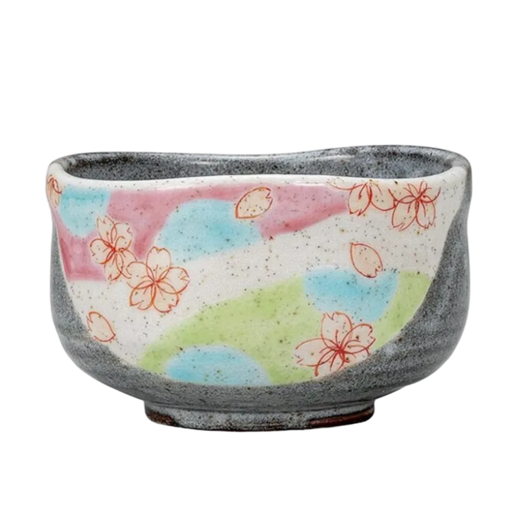 Front view of a hand-painted Kutani Ware matcha bowl with pastel pink, blue, and green color fields and delicate cherry blossom motifs.