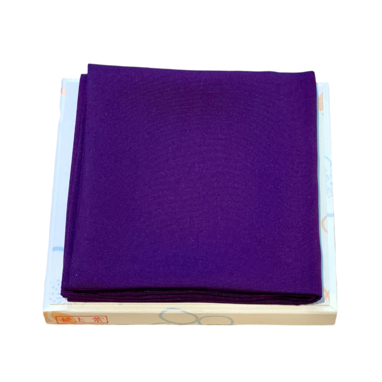 Purple Fukusa fabric folded on a box