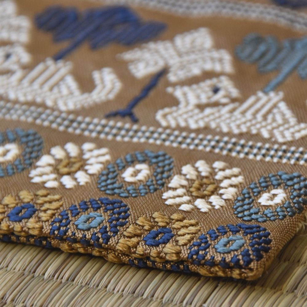 Angled view of a Japanese Nishijin silk kobukusa with historic camel motif