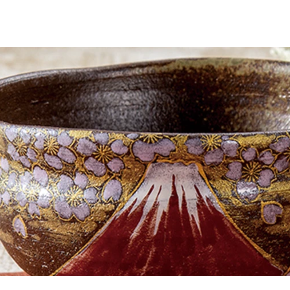 Detailed view of lavender and white cherry blossoms against gold leaf above Mount Fuji, with the dark brown glazed interior visible along the rim.