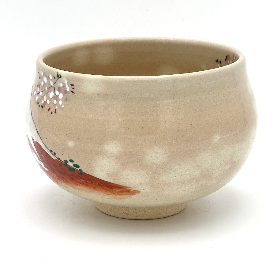 Left-side view of the hand-painted matcha bowl with scattered cherry blossoms and the Red Fuji design wrapping around the base.