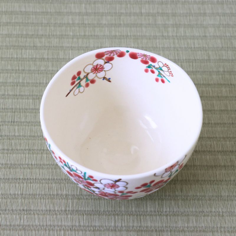 Top view of the red and white plum blossom matcha bowl showing its white interior and flowering branches continuing around the rim.